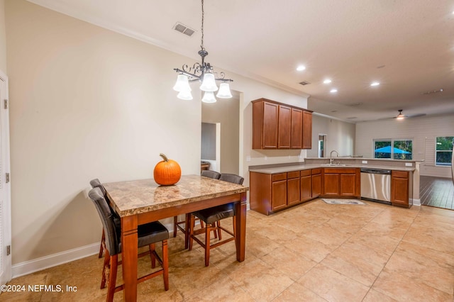 kitchen featuring kitchen peninsula, crown molding, sink, dishwasher, and hanging light fixtures