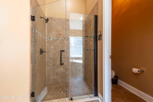 bathroom with tile patterned floors, toilet, and walk in shower