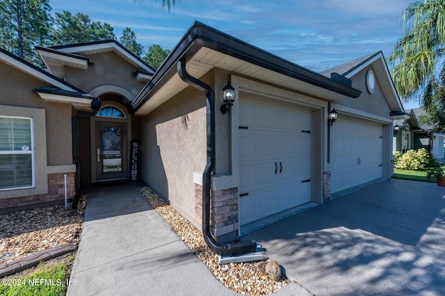 view of exterior entry featuring a garage