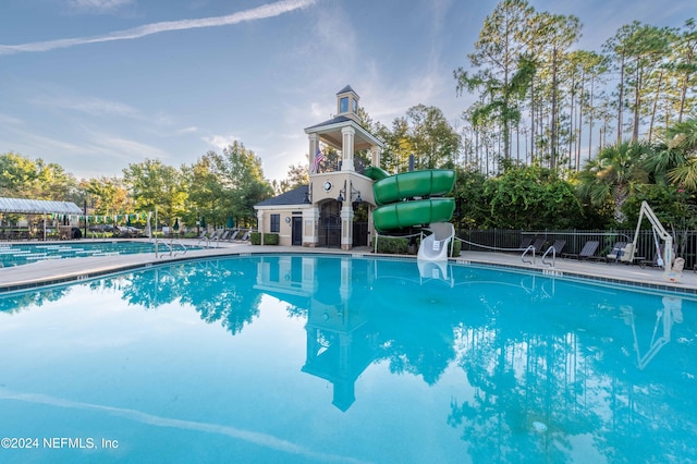 view of swimming pool with a water slide