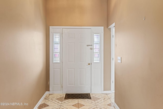 entryway with light tile patterned floors