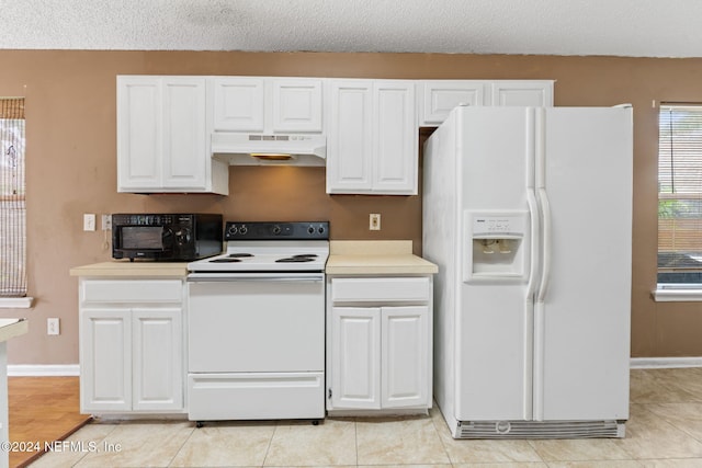 kitchen featuring white cabinetry, a textured ceiling, and white appliances