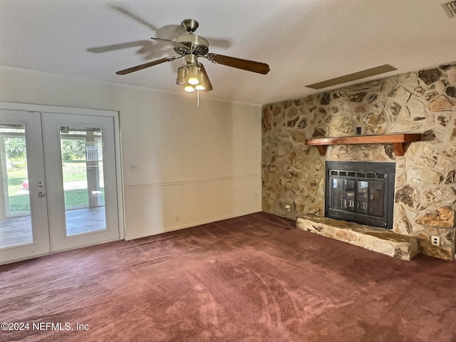 unfurnished living room featuring french doors, carpet floors, a fireplace, and ceiling fan