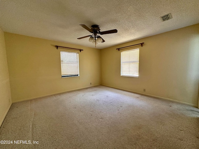 unfurnished room with carpet, a textured ceiling, and ceiling fan