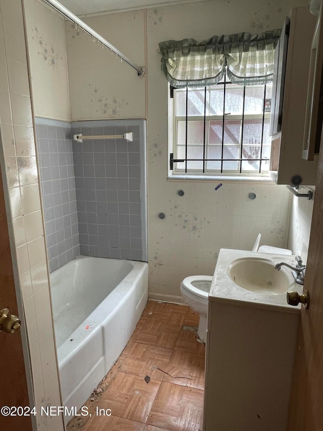 full bathroom with toilet, vanity, parquet flooring, and shower / bath combination