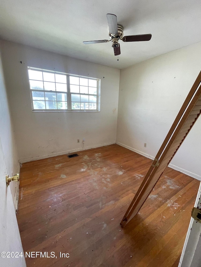 empty room featuring hardwood / wood-style floors and ceiling fan