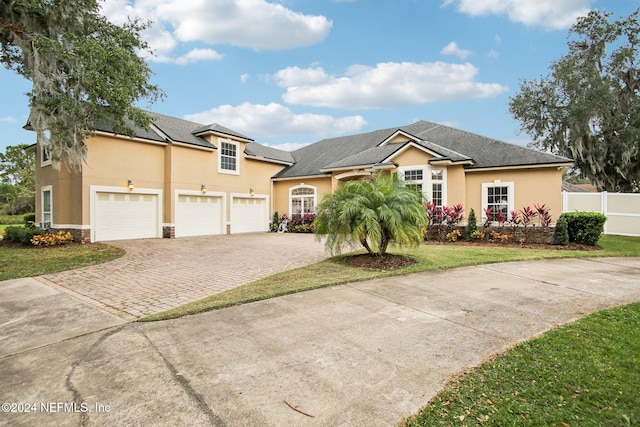 view of front of home featuring a garage and a front lawn