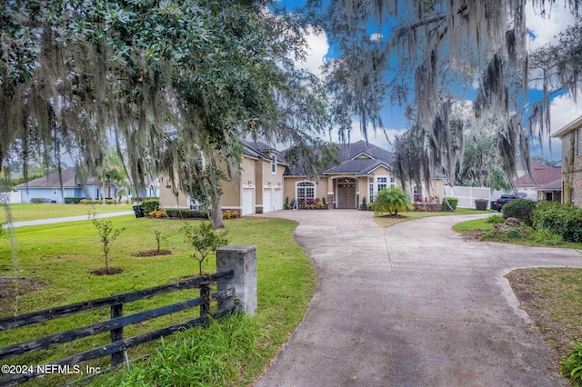 view of front facade with a garage and a front lawn