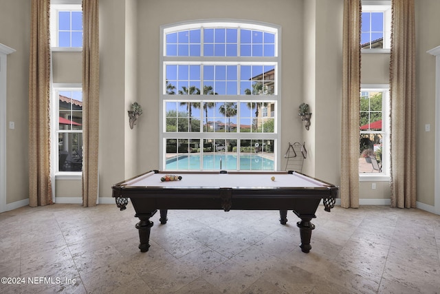 rec room featuring billiards and a towering ceiling