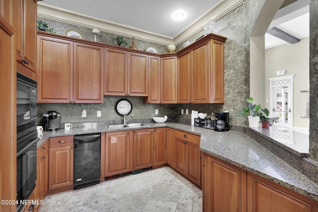 kitchen with sink, stone counters, black appliances, and decorative backsplash