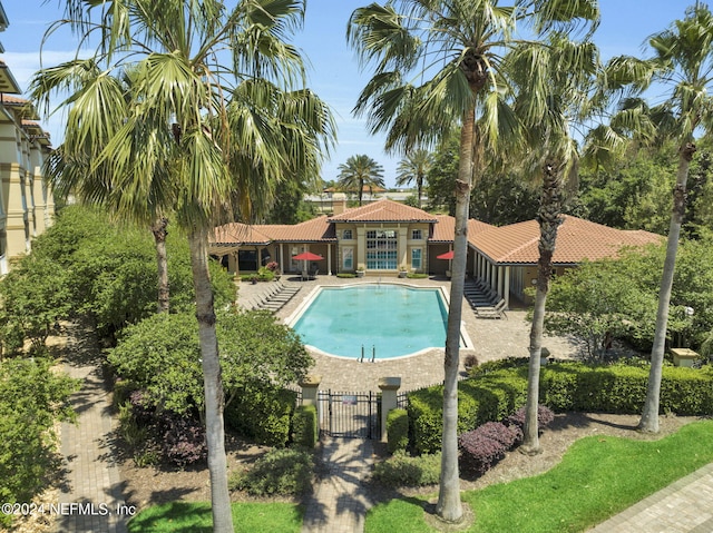 view of swimming pool featuring a patio area and an outbuilding