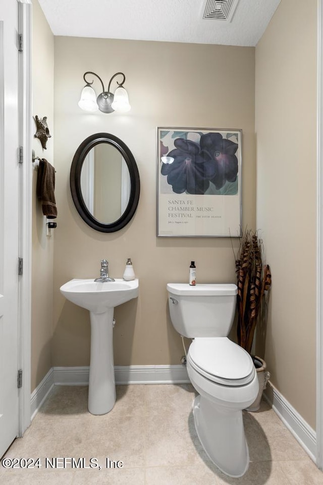 bathroom with tile patterned flooring and toilet