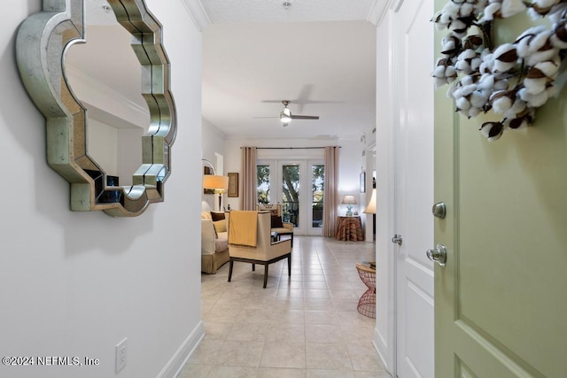 hallway featuring ornamental molding, french doors, and light tile patterned flooring