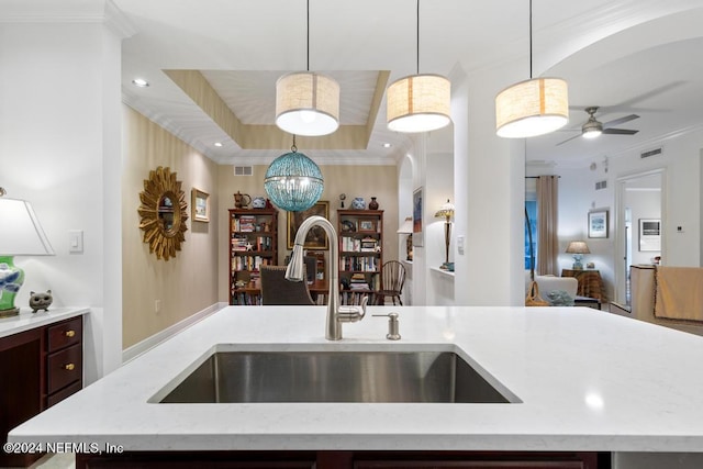 kitchen featuring crown molding, sink, decorative light fixtures, and ceiling fan