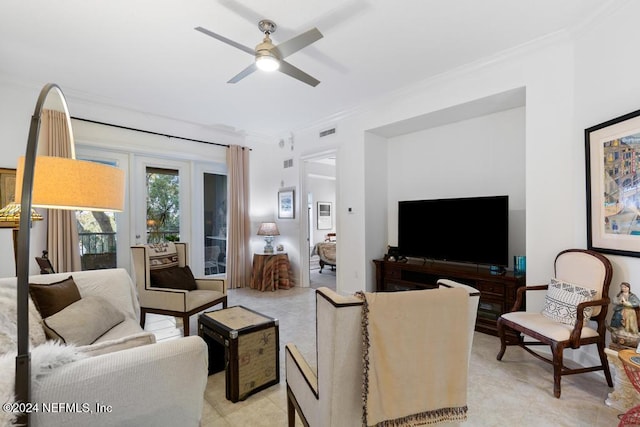 tiled living room featuring ceiling fan and crown molding