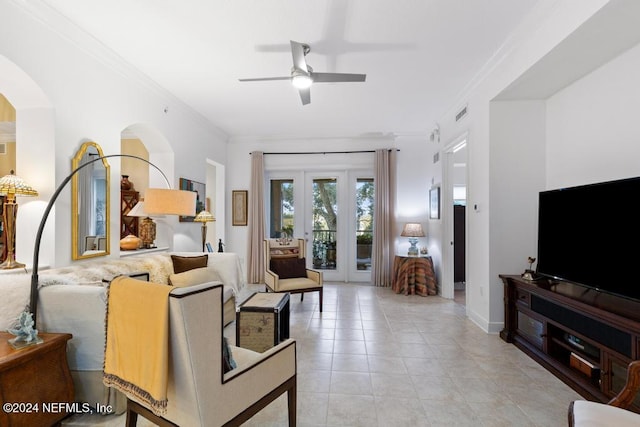 living room featuring light tile patterned flooring, ceiling fan, and ornamental molding