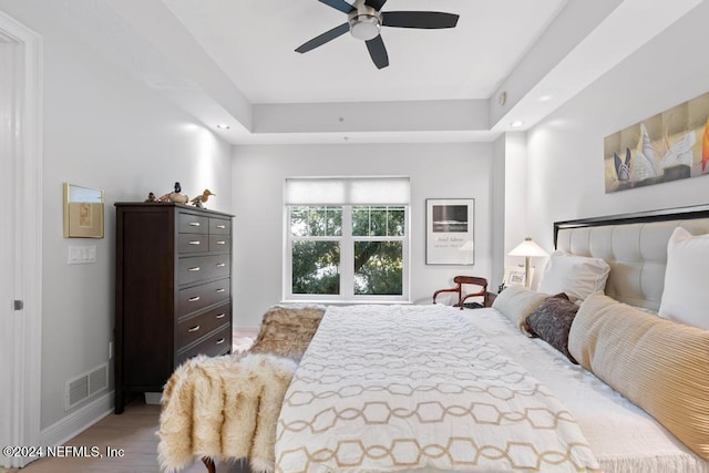 bedroom with ceiling fan and light hardwood / wood-style flooring