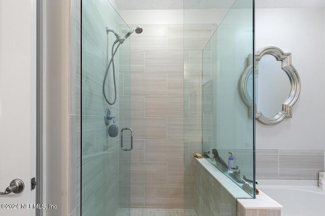 bathroom featuring separate shower and tub