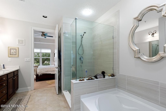 bathroom with ceiling fan, vanity, shower with separate bathtub, and tile patterned flooring