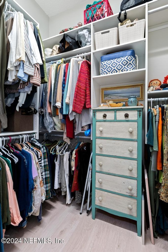 walk in closet featuring light hardwood / wood-style floors