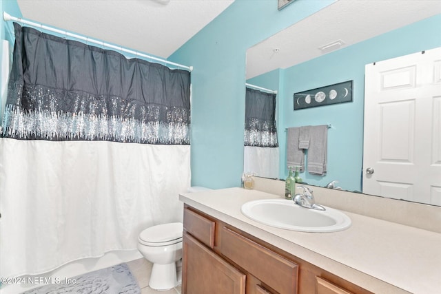 bathroom with vanity, toilet, and tile patterned floors