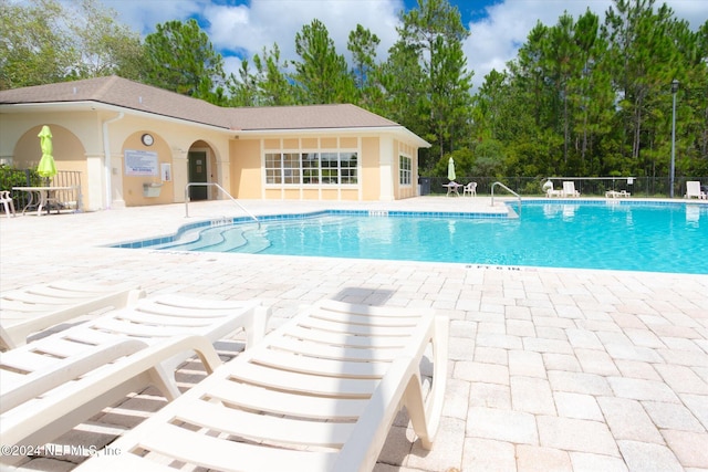 view of swimming pool with a patio area