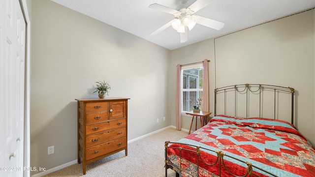 bedroom featuring a closet, ceiling fan, and light colored carpet