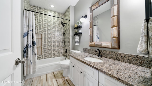 full bathroom featuring vanity, toilet, hardwood / wood-style flooring, and shower / bath combo