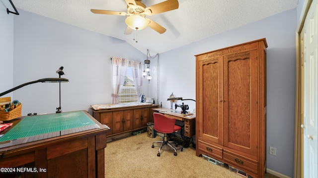 carpeted office featuring lofted ceiling, a textured ceiling, and ceiling fan