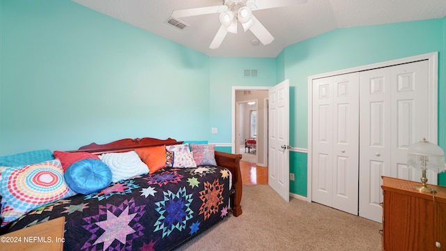 carpeted bedroom featuring a closet, ceiling fan, and lofted ceiling