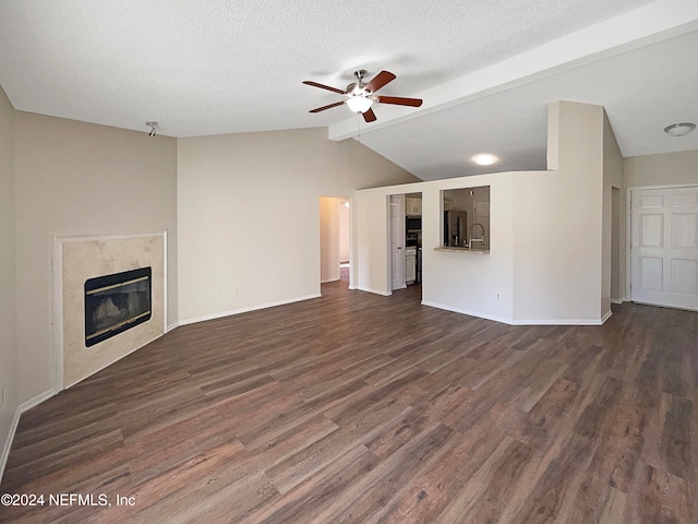 unfurnished living room with a premium fireplace, vaulted ceiling, dark hardwood / wood-style flooring, a textured ceiling, and ceiling fan