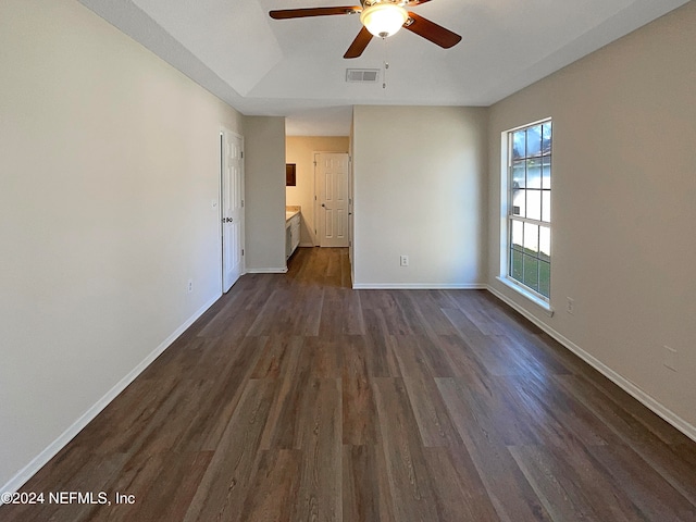 empty room with ceiling fan and dark hardwood / wood-style floors