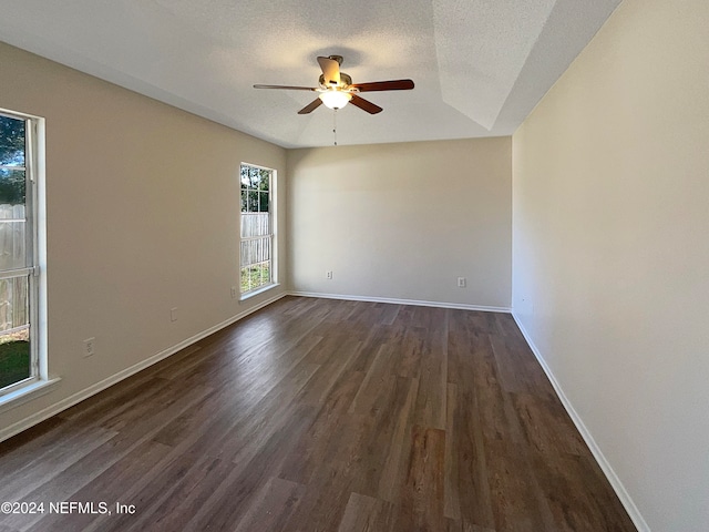 spare room featuring ceiling fan, a textured ceiling, and dark hardwood / wood-style floors