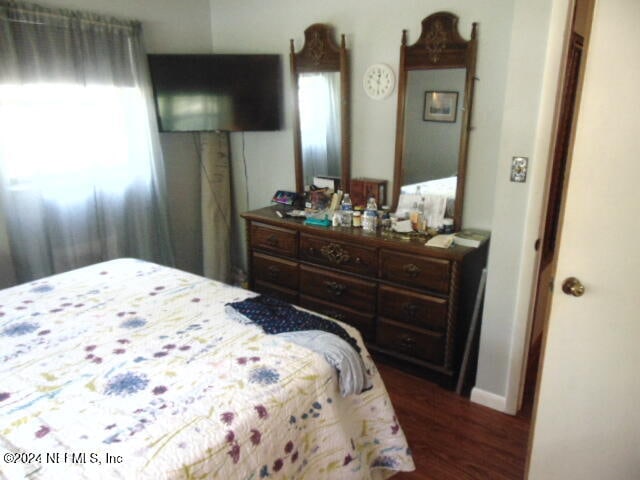 bedroom featuring dark hardwood / wood-style flooring