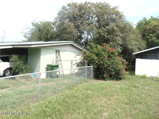 view of home's exterior featuring a carport and a lawn