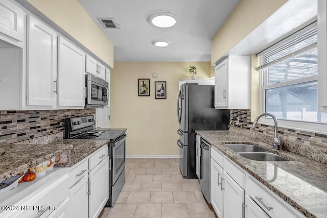 kitchen with sink, white cabinets, and appliances with stainless steel finishes