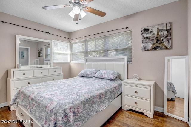 bedroom with wood-type flooring, a textured ceiling, and ceiling fan