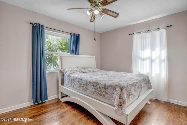 bedroom featuring ceiling fan and hardwood / wood-style flooring