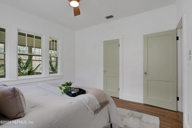 bedroom with ceiling fan and hardwood / wood-style flooring