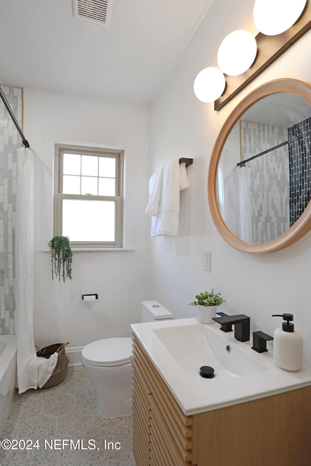 full bathroom with vanity, toilet, tile patterned floors, and shower / bath combo with shower curtain