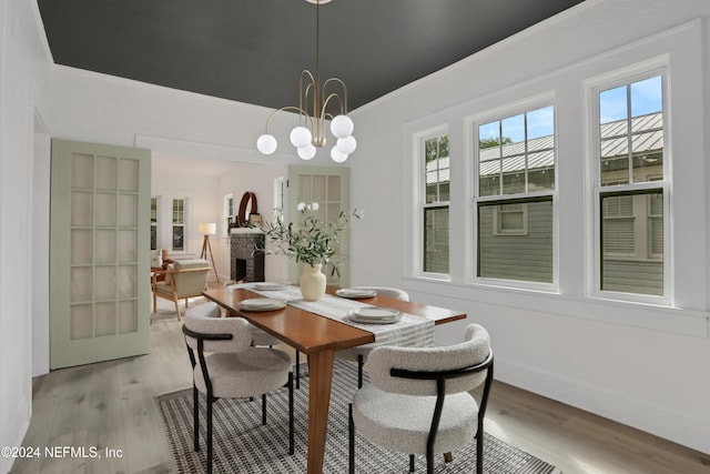 dining area featuring light hardwood / wood-style floors and a chandelier