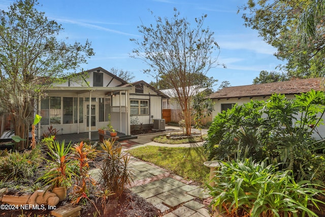 rear view of house with a sunroom and cooling unit