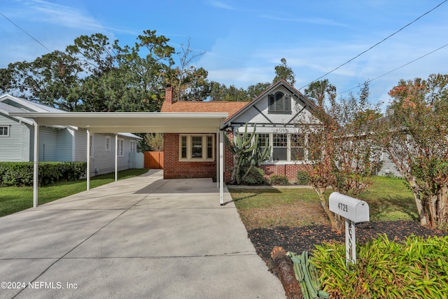 view of front of property with a front yard and a carport