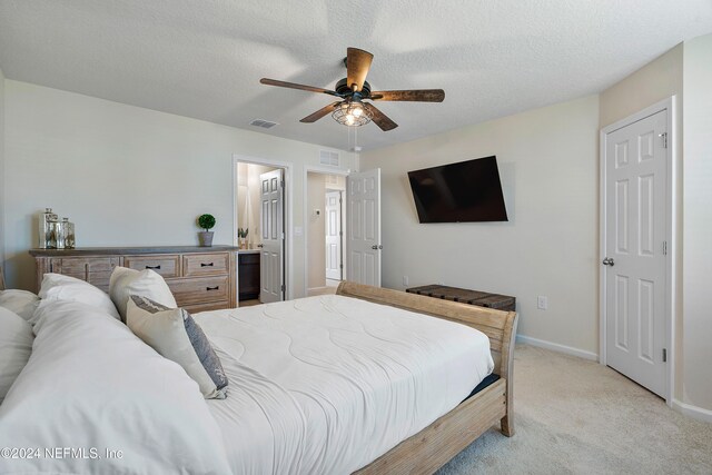 488 Coastline Way, Saint Augustine, FL 32092 - bedroom featuring light colored carpet, baseboards, ceiling fan, a textured ceiling, and ensuite bath