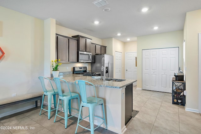 488 Coastline Way, Saint Augustine, FL 32092 - kitchen with appliances with stainless steel finishes, a peninsula, a sink, recessed lighting, and dark brown cabinetry