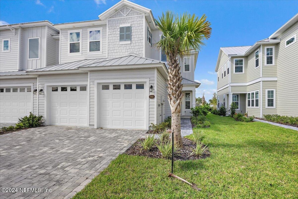 view of front of property with a front lawn and a garage