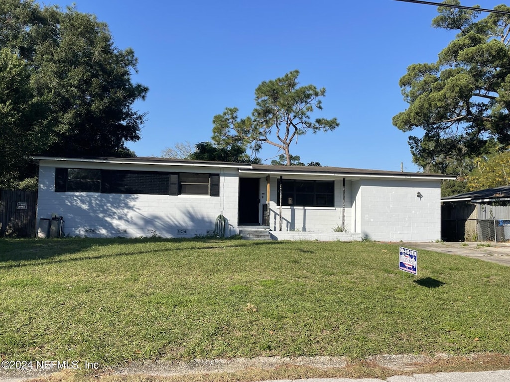 single story home with a front lawn and a garage