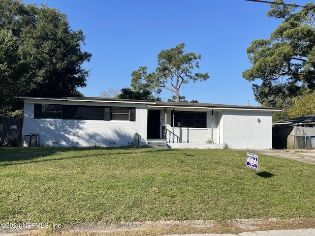 single story home with a front lawn and a garage