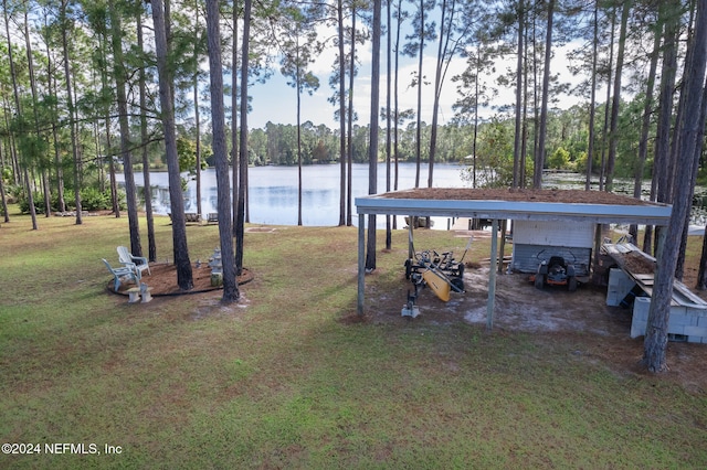 view of dock with a water view and a lawn