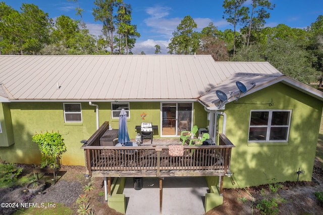 back of house featuring a wooden deck